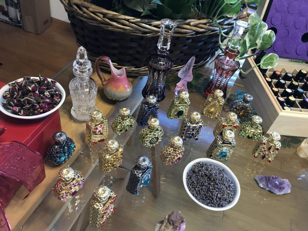 A display of various colorful glass figurines and beads on a table.